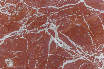 The texture of the red marble slab on the wall