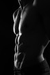 Muscular Torso of Sexy Shirtless Young Male Model Close Up on Black Background