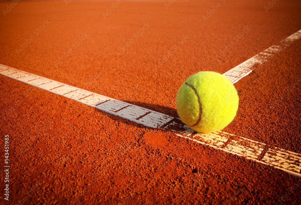 Tennis balls on a tennis clay court - obrazy, fototapety, plakaty 