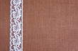 background - brown color burlap hessian with white lace border

