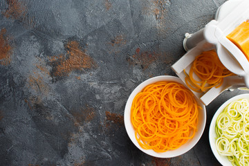 Butternut squash and courgette pasta on the grey stone background, top view, selective focus, copy space for text