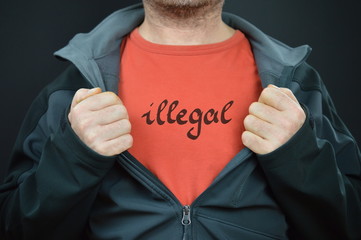 Wall Mural - a man showing his t-shirt with the word illegal on it