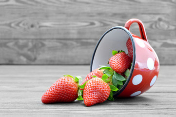 Wall Mural - Bowl of strawberries. Fresh strawberries in the mug on old wooden background