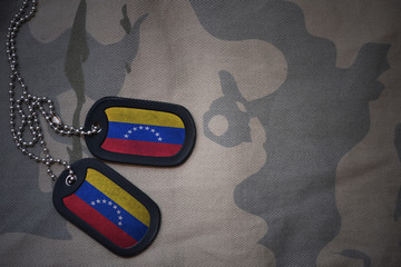 army blank, dog tag with flag of venezuela on the khaki texture background. military concept