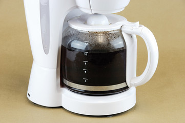 close up on coffee maker isolated on brown background