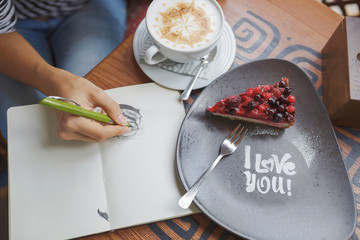 Wall Mural - Young woman sitting indoor in urban cafe