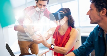 Poster - Businesswoman looking at globe through VR glasses by colleagues