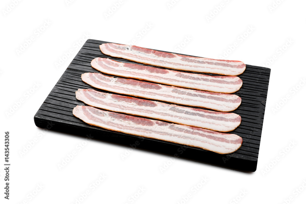 Wooden board with strips of bacon on white background