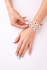 Fotomurales - Delicate women's hands with manicure and bracelet.