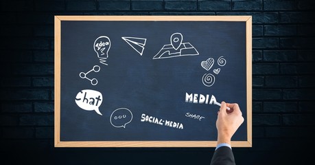 Poster - Cropped image of hand writing on blackboard against brick wall