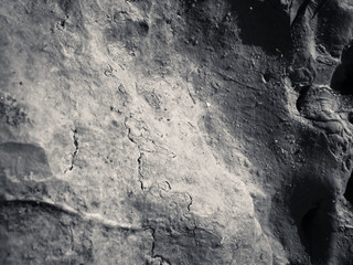 Macro closeup detail on black rough structure mineral, natural grungy textured background