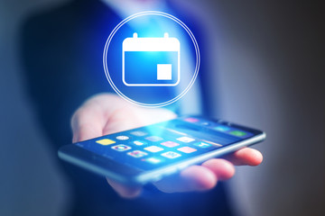 Poster - businessman hand holding mobile phone with calendar icon