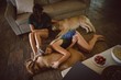 © Wavebreak Media - Friend relaxing with their dog in living room