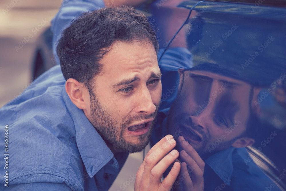 Upset man looking at scratches and dents on his car outdoors - obrazy, fototapety, plakaty 