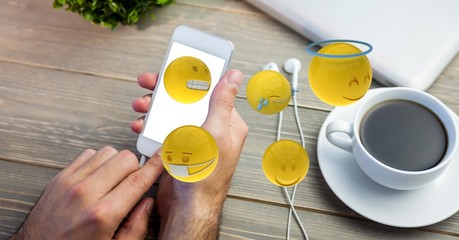 Poster - Cropped image of man using smart phone with various emojis