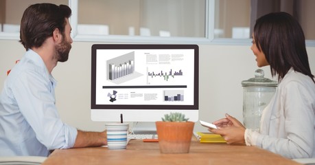 Poster - Business colleagues analyzing graphs on desktop PC