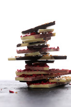 Chocolate Bars On A Wooden Background With Chocolate Tower