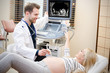 © Proxima Studio - Pregnant woman at the doctor. Ultrasound diagnostic machine