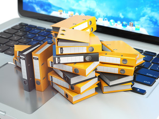 Poster - Laptop and pile of file cabinet with ring binders. Database, archive, computer data storage, office paperwork and electronic document management concept.