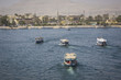 Wooden boats carrying passengers docked along the Nile River in Aswan, Egypt, North Africa