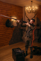 Wall Mural - Hunter man aims of the antique hunting rifle