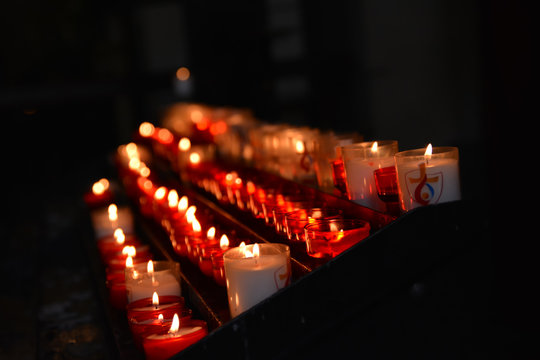row of many burning candles