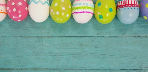 Wall Mural - Various Easter eggs arranged on wooden surface