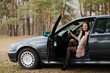 © combo1982 - Portrait of a very beautiful girl in a forest dressed in fur in a car