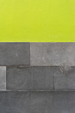 Background / Detail Of A Facade With Gray Stone And Green Wall Paint 