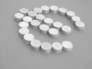 A sumbol of the Euro from coins. Stacks of coins. Black and white concept.