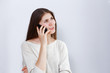 © mark_ka - Portrait of young woman talking on the phone. Human reaction, expression. Grey background.