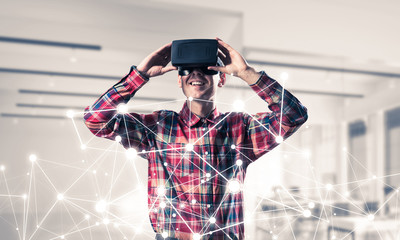 Guy wearing checked shirt and virtual mask demonstrating some em