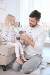 Canvas Print - Father and his daughter with cat at home