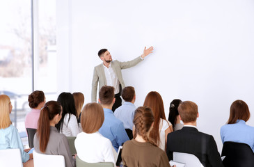  Business trainer giving presentation to group of people