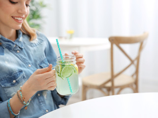 Wall Mural - Beautiful young woman with lemonade in cafe