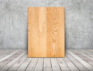 Leinwandbilder - Blank wood plain frame leaning at concrete wall on wooden plank floor in perspective room,Business mock up presentation design