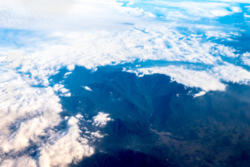 Wall Mural - Aerial view of airplane window looking down to land ,Nature background