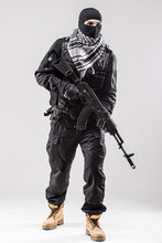 Terrorist Holding A Machine Gun In His Hands Isolated Over White