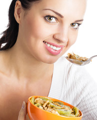 Woman eating muesli or cornflakes, isolated