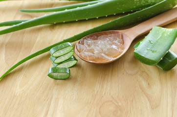 Wall Mural - sliced and leaf of fresh aloe vera with aloe vera gel product on wooden