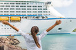 Happy carefree freedom woman in front of cruise ship. Caribbean luxury travel vacation concept.