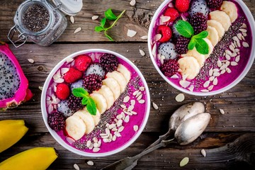 Wall Mural - Blueberry smoothie bowl with banana, raspberry, pitaya, blackberry, almonds, sunflower and chia seeds
