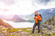 © lkoimages - Young man hiking on Besseggen. Happy guy enjoy beautiful lake and good weather in Norway. Toning picture