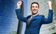 © Minerva Studio - Portrait of a andsome businessman raising arms in sign of victory