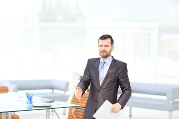 Businessman offering his hand for handshake. Greeting or congratulating gesture. Business meeting and success