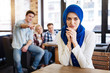 Beautiful pleasant muslim woman sitting in the cafe