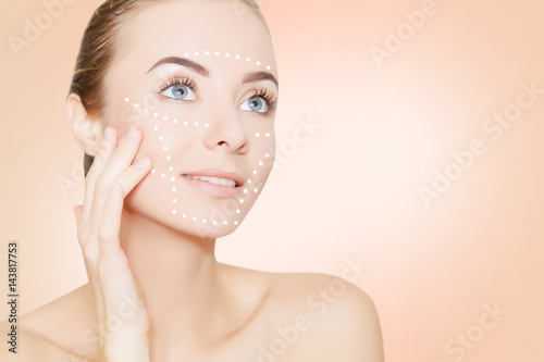 Fotografering Woman face with marks and arrows on pink