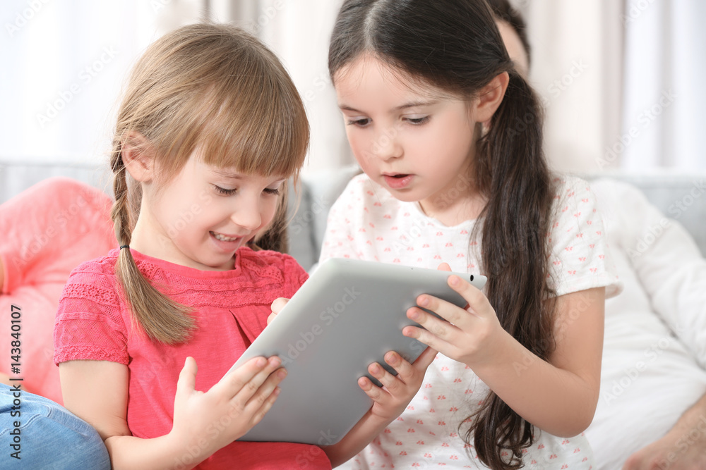 Little girls with tablet at home