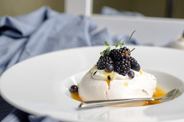 Pavlova dessert with passion fruit sauce