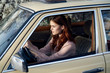 © SHOTPRIME STUDIO - young woman with red hair behind the wheel of a car confident look...